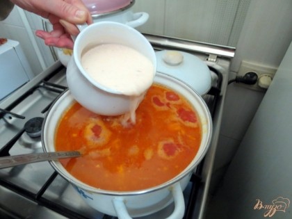 В чашку отливаем немного супа, жидкую часть. Добавляем сметану, муку и быстро размешиваем, чтобы не было комочков. Если так делать, магазинная сметана не сворачивается, а равномерно растворяется. Содержимое выливаем в суп.