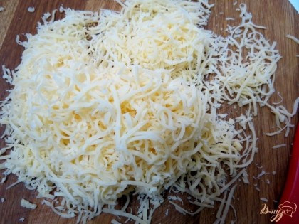 Сыр натираем на мелкой тёрке и делим на 2 части.