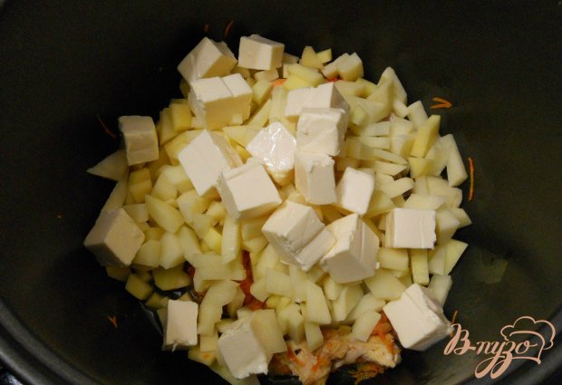 К мясу и овощам добавить порезанные - небольшими кусочками картофель и кубиками - плавленные сырки.