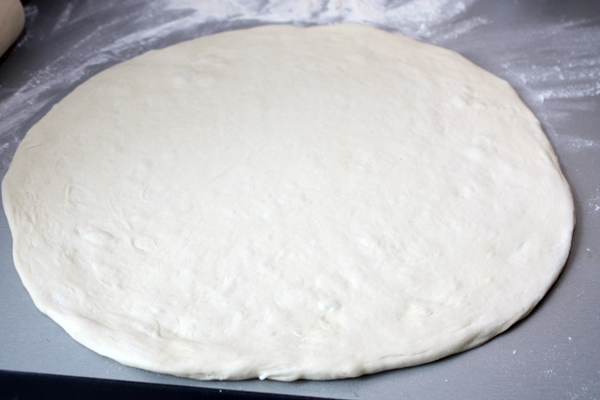Когда тесто будет готово, раскатайте его в круг толщиной в полсантиметра и выложите не посыпанный мукой противень.