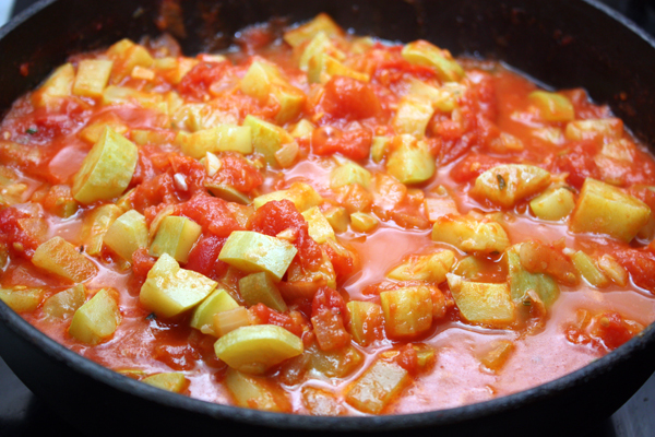 Размяв томаты, тушим овощи без крышки на небольшом огне около 20 минут, чтобы они стали довольно мягкими, а соус немного загустел.