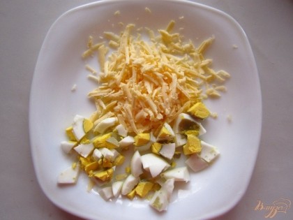 Сыр натрите на большой терке, яйца сварите и нарежьте.