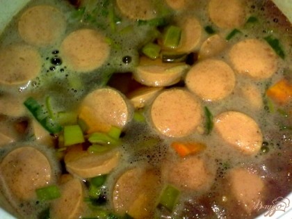 В кипящий бульон положите чечевицу, морковь и картофель. Доведите до кипения и добавьте сосиски, лук-порей и соленый огурец. Варите до готовности. За 5 минут до готовности добавьте соль, перец, лавровый лист и приправу для супа.