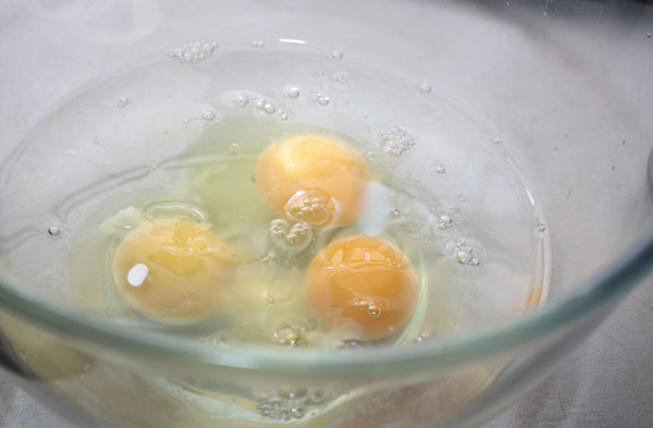 Разбиваем в миску яйца, добавляем соль и сахар (одну-две столовые ложки).  