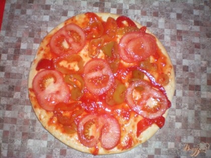 Порежем помидор кружочками и выложим на пиццу.