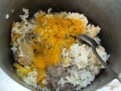  После добавляем рис сверху и тушим долив воды так, чтобы она покрыла рис на 2 пальца в высоту. Готовим рис до полу готовности. После добавляем куркуму и перемешиваем. Довариваем рис.