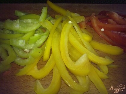 Болгарский перец возьмите разных цветов. Перец вымойте, удалите плодоножки и нарежьте соломкой.