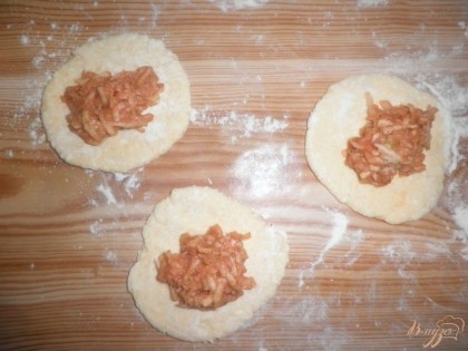 Далее делим тесто на 10 равных комочков. Раскатываем наши комочки скалкой и выкладываем яблочную начинку