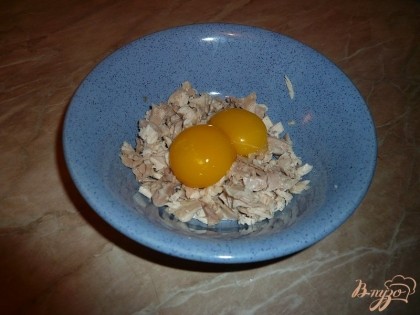 Выкладываем мясо в небольшую плошку, затем добавляем к нему два куриных яйца.