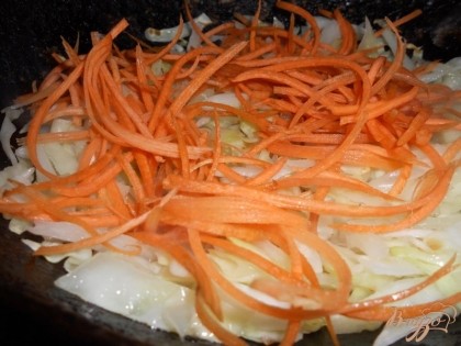 В сковороду к капусте с луком выкладываем половину моркови, перемешиваем овощи и жарим еще минут пять — нижняя часть шубы на этом готова.