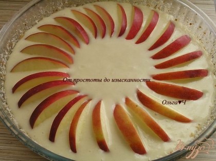 Выложить тесто в форму для выпечки, смазанную маслом и посыпанную панировочными сухарями. Сверху разложить яблоко, нарезанное дольками.