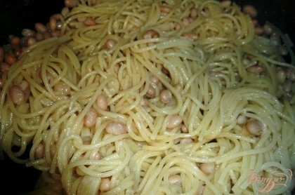 После этого выкладываем в сковороду отваренные спагетти, хорошо перемешиваем их с фасолью и томим на медленном огне под крышкой, чтобы спагетти как следует пропитались ароматом чеснока.