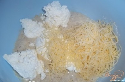 К подошедшей опаре добавить оливковое масло, соль, творог, слегка взбитое яйцо, натертый на мелкой терке сыр.