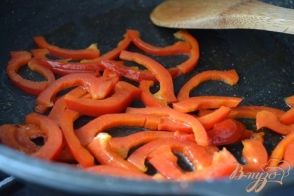 На оливковом масле обжарить сладкий перец, немного посолить по вкусу . Затем  быстро обжарить рыбное филе и полоски бекона.