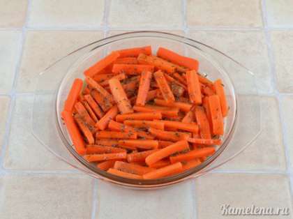 Посыпать тмином, мускатным орехом, щепоткой соли.  Полить медом и растительным маслом, перемешать, чтобы морковь равномерно покрылась всеми добавками.