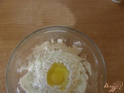 Вбейте туда, в ямку, куриное яйцо, высыпьте соль и перемешайте тесто. Дальше постепенно подливайте холодную воду одной рукой, второй медленно замешивая тесто.