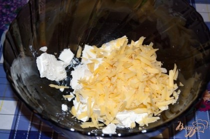 Приготовьте начинку. Разломайте вилкой сыр Фета. Натрите на терку твердый сыр.