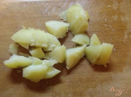 Картофель вымойте его и, не очищая, отварите до готовности. После остудите, очистите от шкурки и нарежьте крупными кубиками размером около 4 на 4 см. Лучше использовать картофель мягких сортов, он слаще.