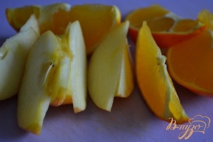 Половинку апельсина и яблока нарезать на дольки.