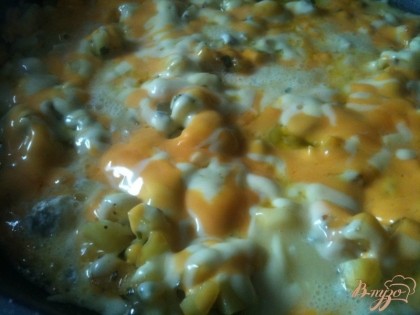 Тертый сыр расположить на поверхности обжаренного картофеля. Мягкий сыр выложить небольшими порциями . Накрыть крышкой и оставить на тихом огне на 5-7 мин.