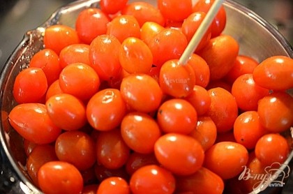 Промоем помидоры под проточной водой. Затем воду слить. Каждый томат проткнуть зубочисткой или шпажкой.
