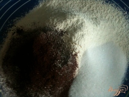На рабочий стол просеять муку с какао, добавить сахар и щепотку соли. Перемешать.