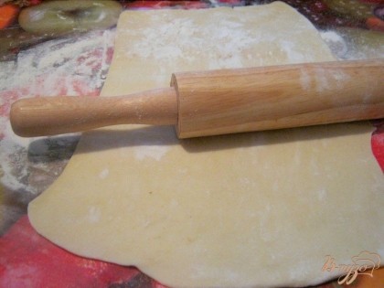 Слоеное тесто положить на присыпанную мукой поверхность и раскатать в тонкий пласт.