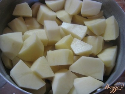 Картофель необходимо очистить, вымыть, разрезать на средние кубики, уложить в кастрюлю.