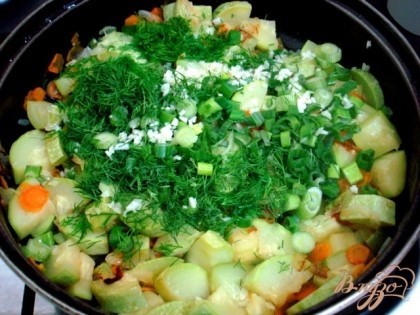 Когда овощи почти готовы добавляем мелко нарезанную зелень и рубленный чеснок.