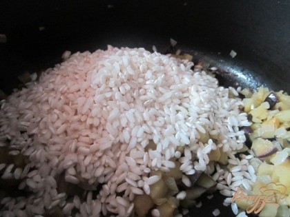 Всыпать рис, перемешать и оставить на 1 мин.