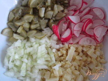Уложить в салатник картофель, редис, репчатый лук и маринованные огурцы.
