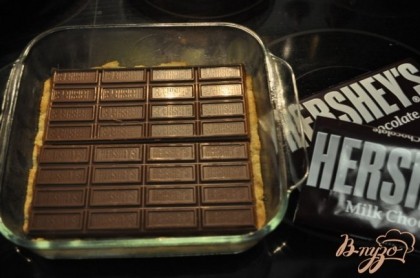 Положить сверху готового бисквита шоколад, можно поломать, если нужно полностью закрывая поверхность.