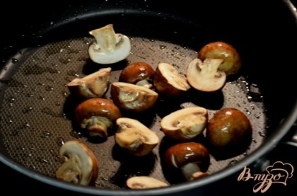 Разогреть на сковороде средне-высоком огне 2 стол.л оливковое масло. Добавить грибы и обжаривать примерно 7 мин. Посолить и поперчить. Переложить на тарелку.