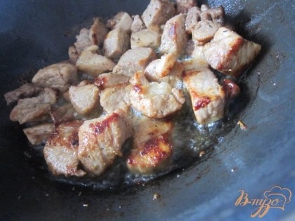 В глубокой сковороде на оливковом масле поджарить кусочки мяса.