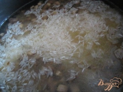 Всыпать рис и залить водой так чтобы закрыть рис ( еще зависит от сорта риса)Посолить, накрыть крышкой и поставить на тихий огонь.