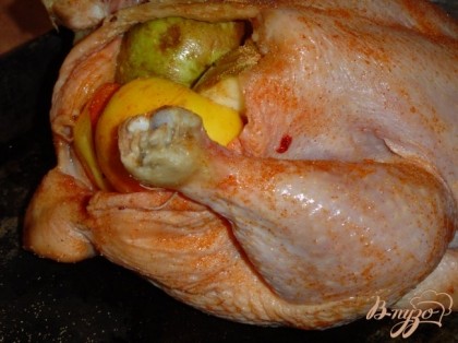 Натираем курицу сверху и внутри специями и солью.Начиняем курицу яблоками и разрезанным на две части лимоном.