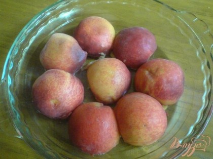 Персики вымойте, разрежьте на половинки, удалите косточки.Форму смажье жиром. В форму уложите персики срезом вниз.