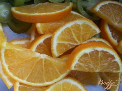 Апельсины вымыть щеточкой. Один апельсин, не очищая кожуры, нарезать полукольцами. 3-4 помидорки нарезать кружочками.