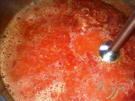 Достаем базилик из томатной массы, выжимаем весь сок из него в эту массу и измельчаем ее блендером.