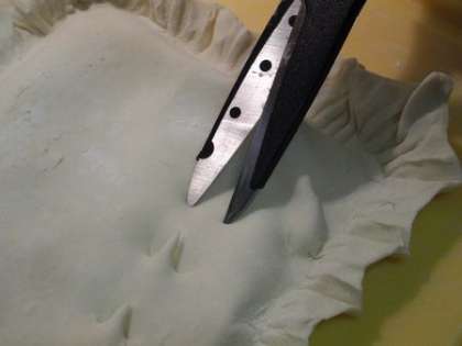 Ножницами сделать надрезы вдоль пирога