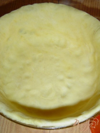 Раскатываем тесто, выкладываем его в смазанную маслом форму, делаем бортики.