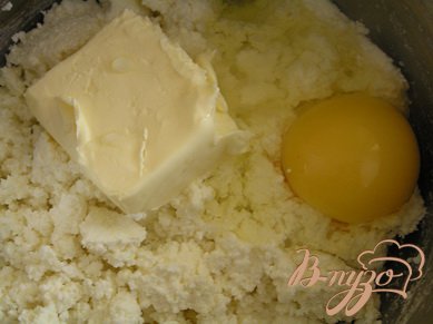 Как только сыворотка стечет, выложить еще теплую сырную массу обратно в кастрюльку. Добавить яйца, масло, соль и соду (это для пористости, но на вкус Вы её не почувствуете).