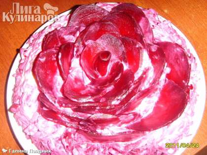 Салат &quot;Черная роза&quot; украшаем розой из свеклы.  Для этого отварить свеклу, разрезать ее пополам и нарезать тонко пластинами наискосок. Затем укладываем пластинки свеклы в виде розы.