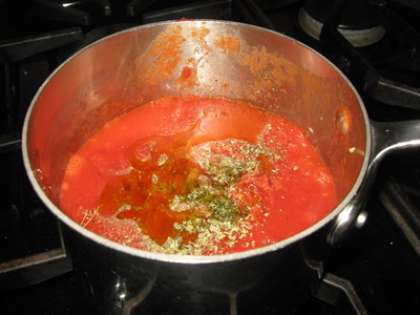 Теперь нарубите мелко базилик. На крупной терке натрите сыр моцарелла. Помидоры очистите от кожуры, помните хорошенько своими руками до желаемой консистенции и выложите в сковороду. Как только томаты начнут закипать, добавляем оливковое масло, перец, соль и орегано. Тщательно перемешиваем и варим на протяжении 10 минут.