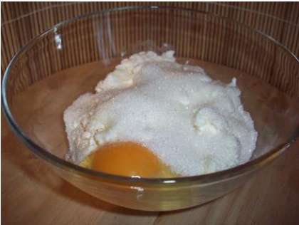 В приготовленную миску выложите творог, разомните его хорошо вилкой  или протрите через сито, вбейте одно яйцо и добавьте сахар. Можно добавить немного соли и ванилина. Тщательным образом все перемешайте, у вас должна получиться однородная масса желтоватого цвета.