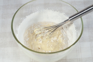 В глубокую емкость вылейте сливки, добавьте одно яйцо, соль, сахар и ванилин. Просейте муку, добавьте к ней разрыхлитель и постепенно добавляйте в приготовленную смесь.
