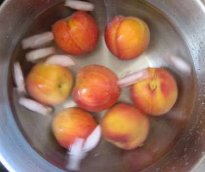 Помойте персики. Потом вскипятите воду. Бланшируйте плоды, для того, чтобы максимально раскрыть их вкус и снять кожицу, которая дает терпкость и кислоту в компоте. Для этого переложите плоды в кипяток.