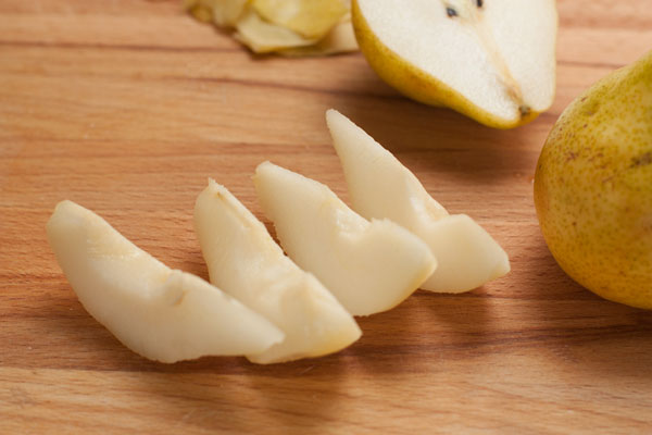 Груши почистите, удалите сердцевину и нарежьте дольками. Чтобы они не успели потемнеть делайте все быстро или сбрызните их лимонным соком.