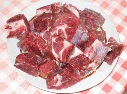 Очистите мясо от сухожилий и пленок. Можете его не мыть, а просто тщательно оскоблите острым ножом кусок (куски) мяса. Таким образом, весь мясной сок сохранится в мясе. Порежьте говядину кусочками размером примерно 2х2 см.