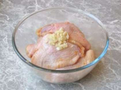 Выдавите чеснок через чеснокодавку и добавьте к курице, также добавьте специи, перемешайте.